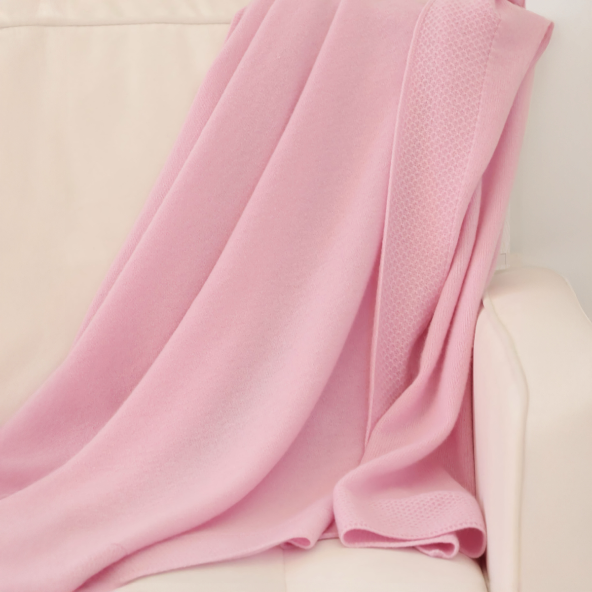 Draped Alashan Hayden Honeycomb Edge Knit Baby Blanket in Beach Pink