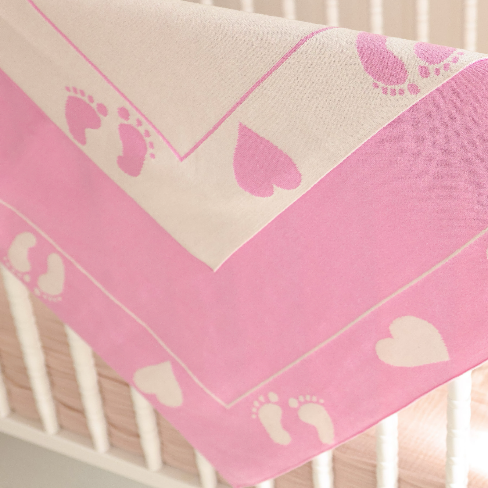 Draped Alashan Stevie Knit Baby Blanket in Bubble Gum