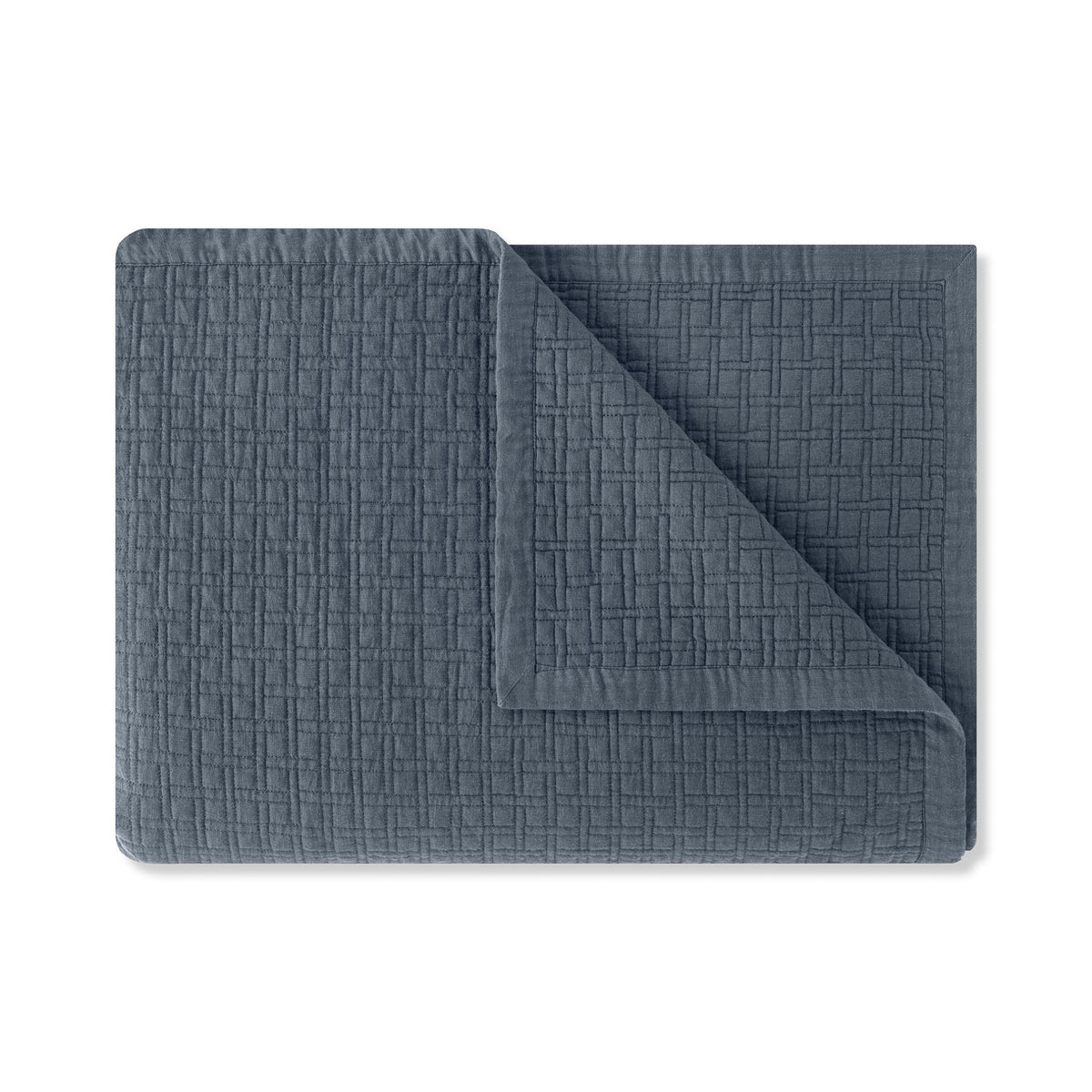 A folded Loch Blue Amalia Adorno Quilted Coverlet
