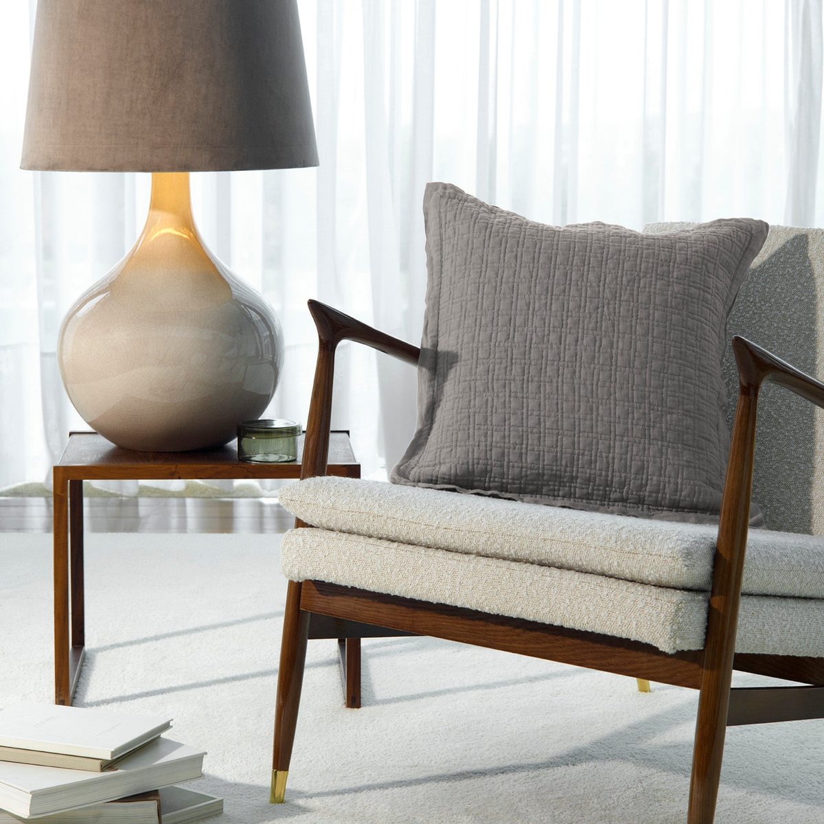 Grey Amalia Adorno Quilted Euro Shams on a modern armchair