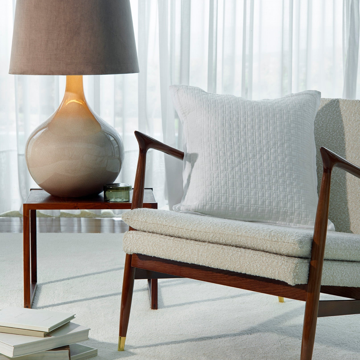 White Amalia Adorno Quilted Euro Shams on a modern armchair