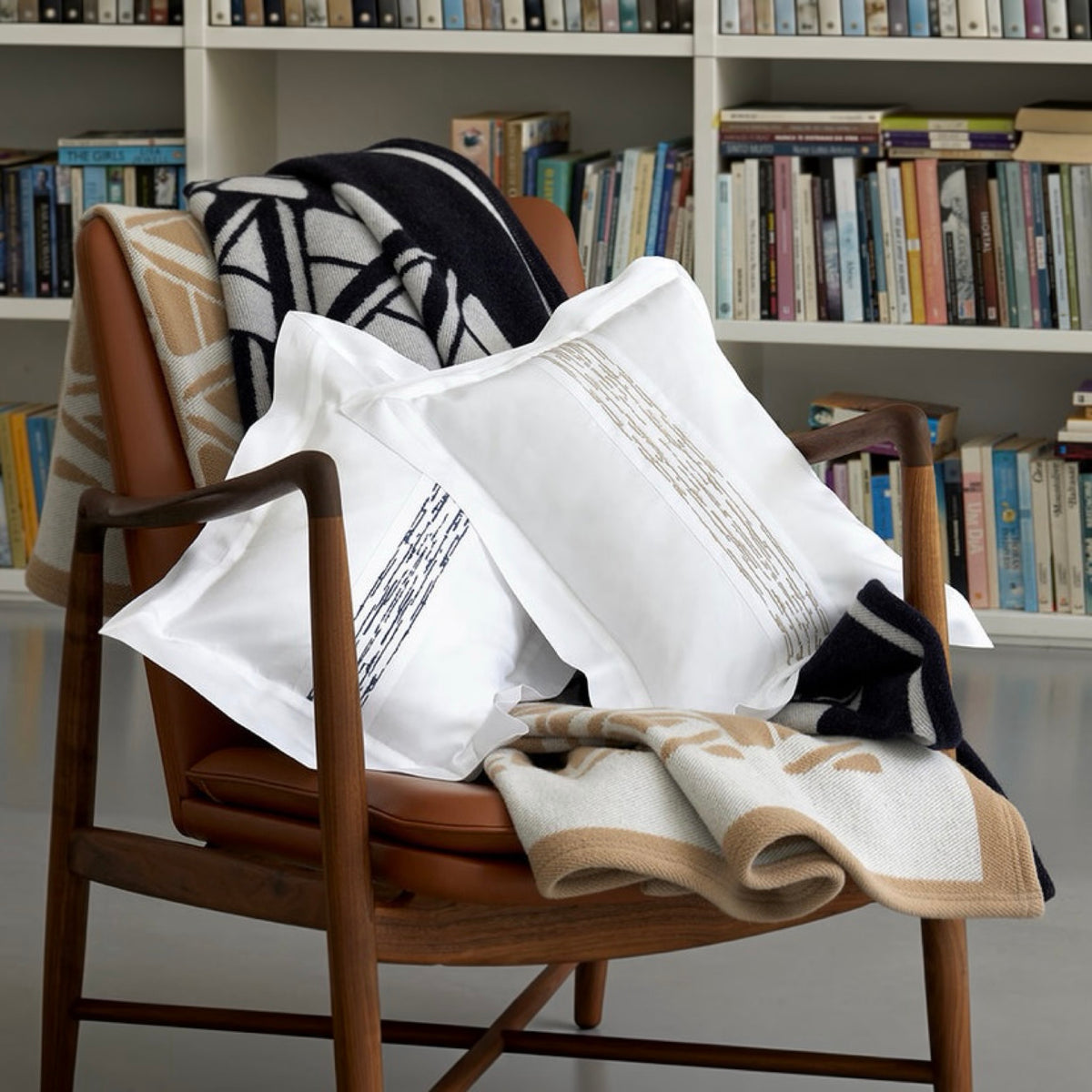 Midnight Amalia Ama Throw on an armchair with white pillows