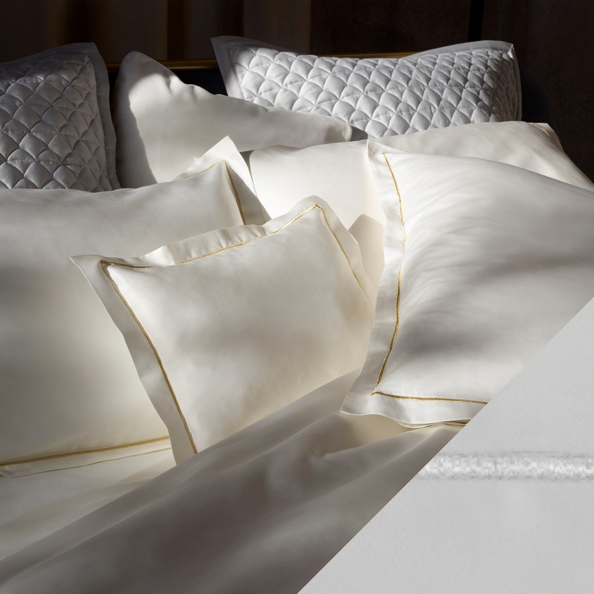 Closeup of Cream Gold Amalia Dalia Shams with White and Silver swatch