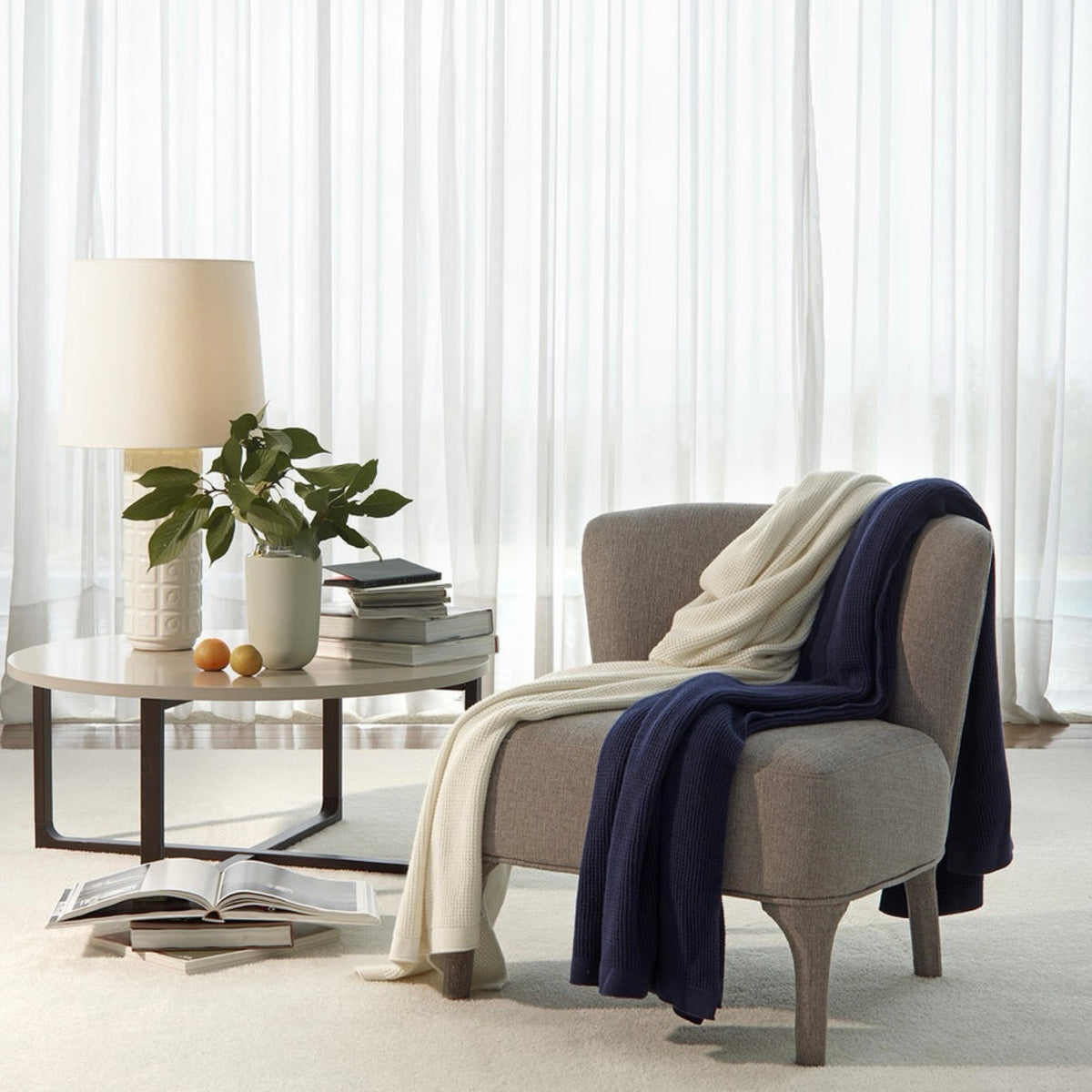 Amalia Elemento Throws in midnight and cream colors on a couch