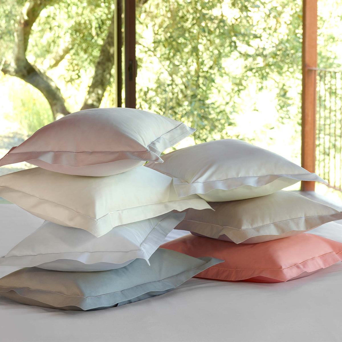 Different colors of Amalia Fresco Giza 94 Shams in front of a window