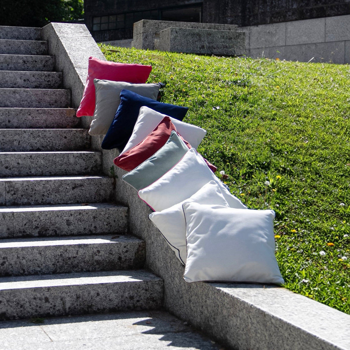 Amalia Jaya Velvet Decorative Pillows on a stair