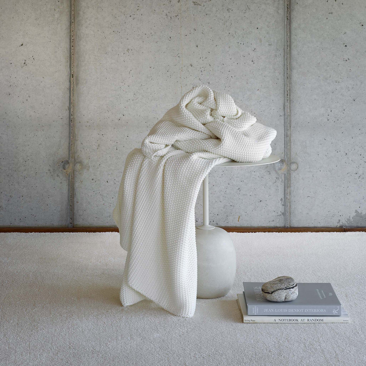 Amalia Lilium Throws in Natural color draped on a table