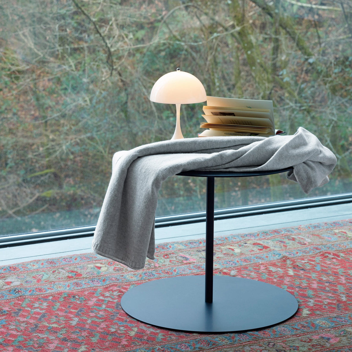 Cool Grey Amalia Lucia Throw draped on a small table