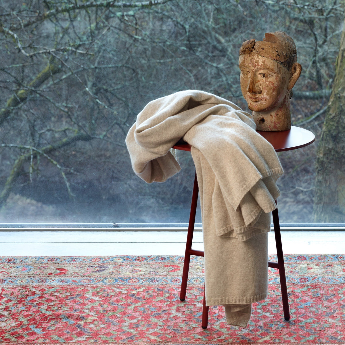 Natural Amalia Lucia Throw draped on a small table