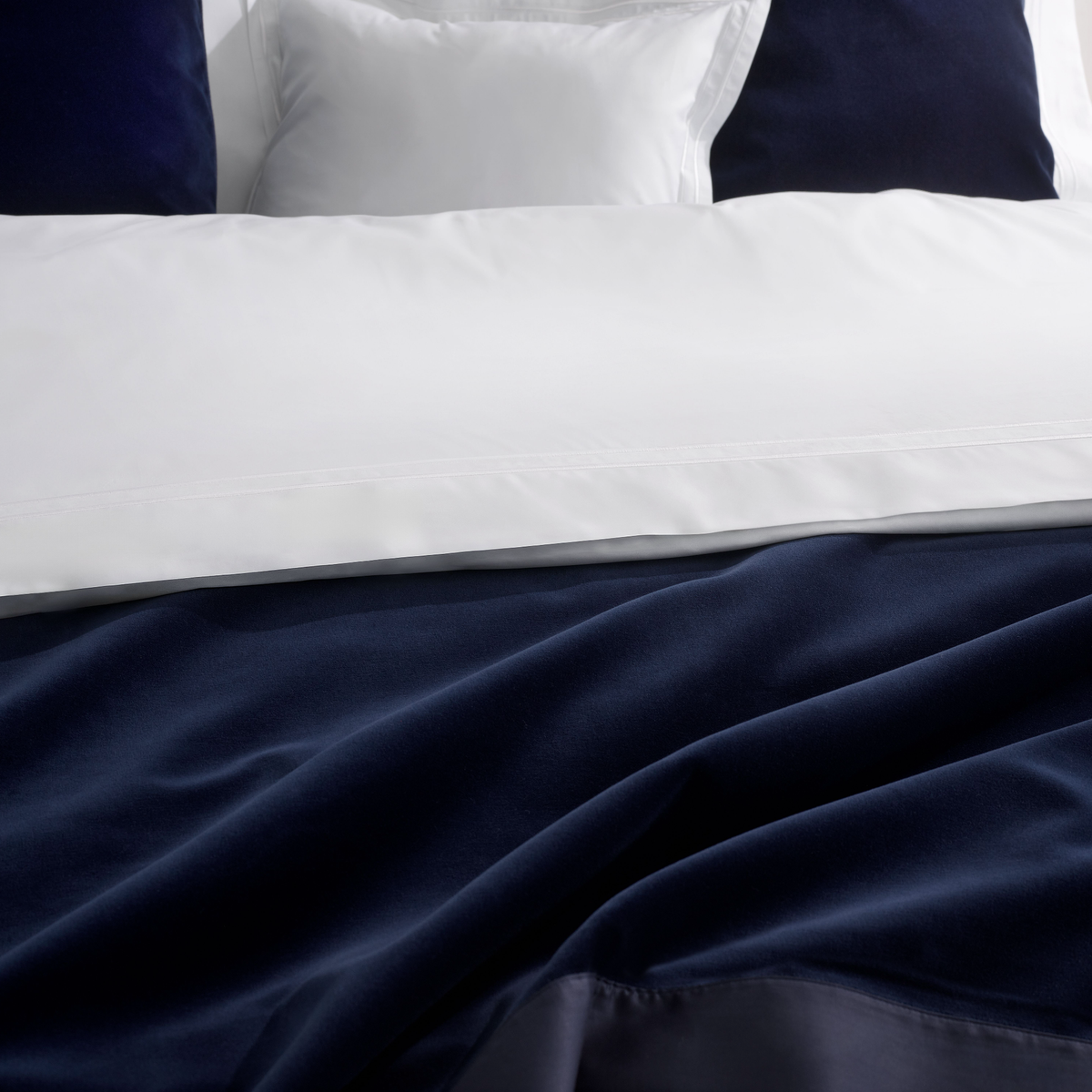 Closeup View of White Amalia Pleno Giza 45 Cotton Bedding with Navy blue coordinate