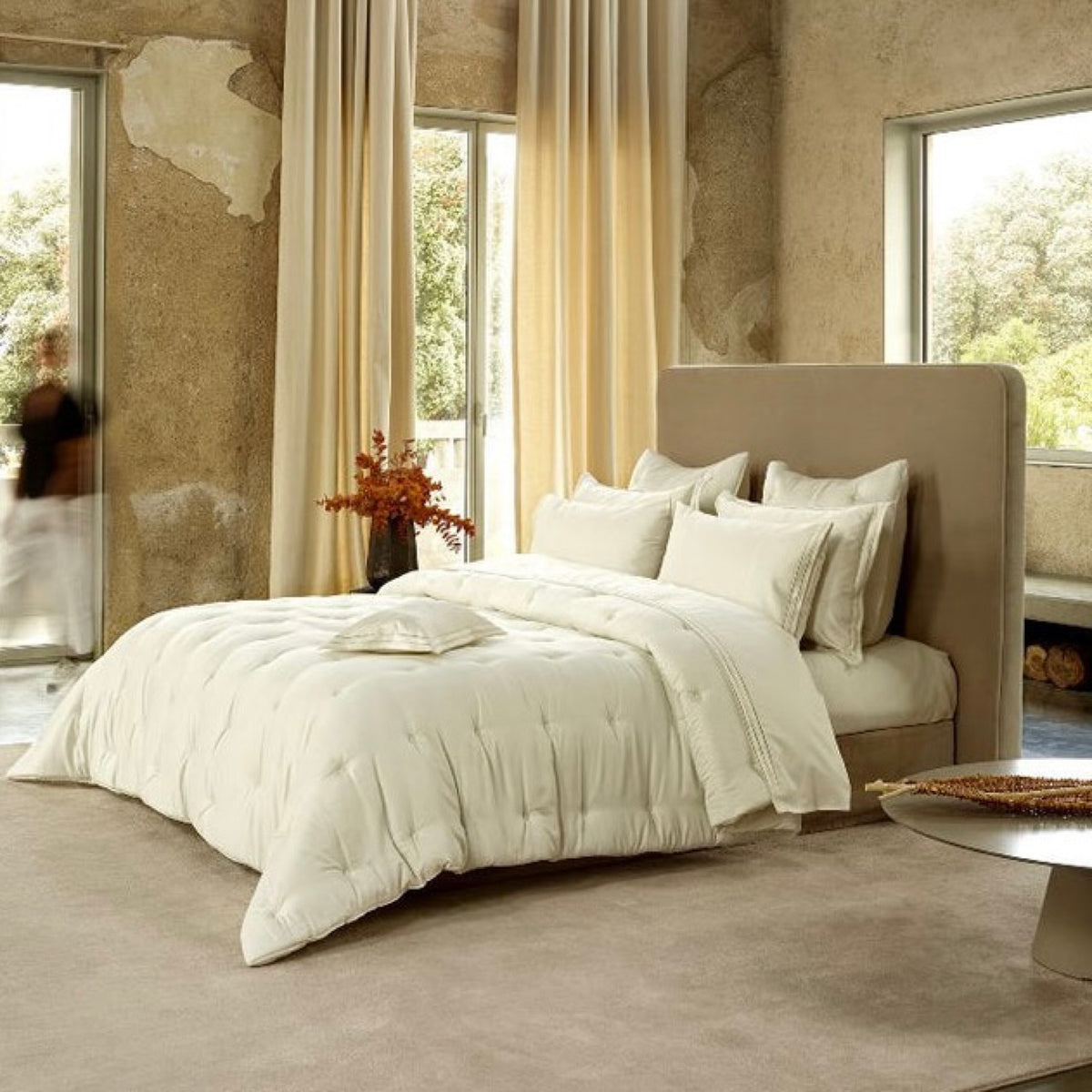 Bed with Cream Amalia Savia Quilted Bedding in a room with high ceiling