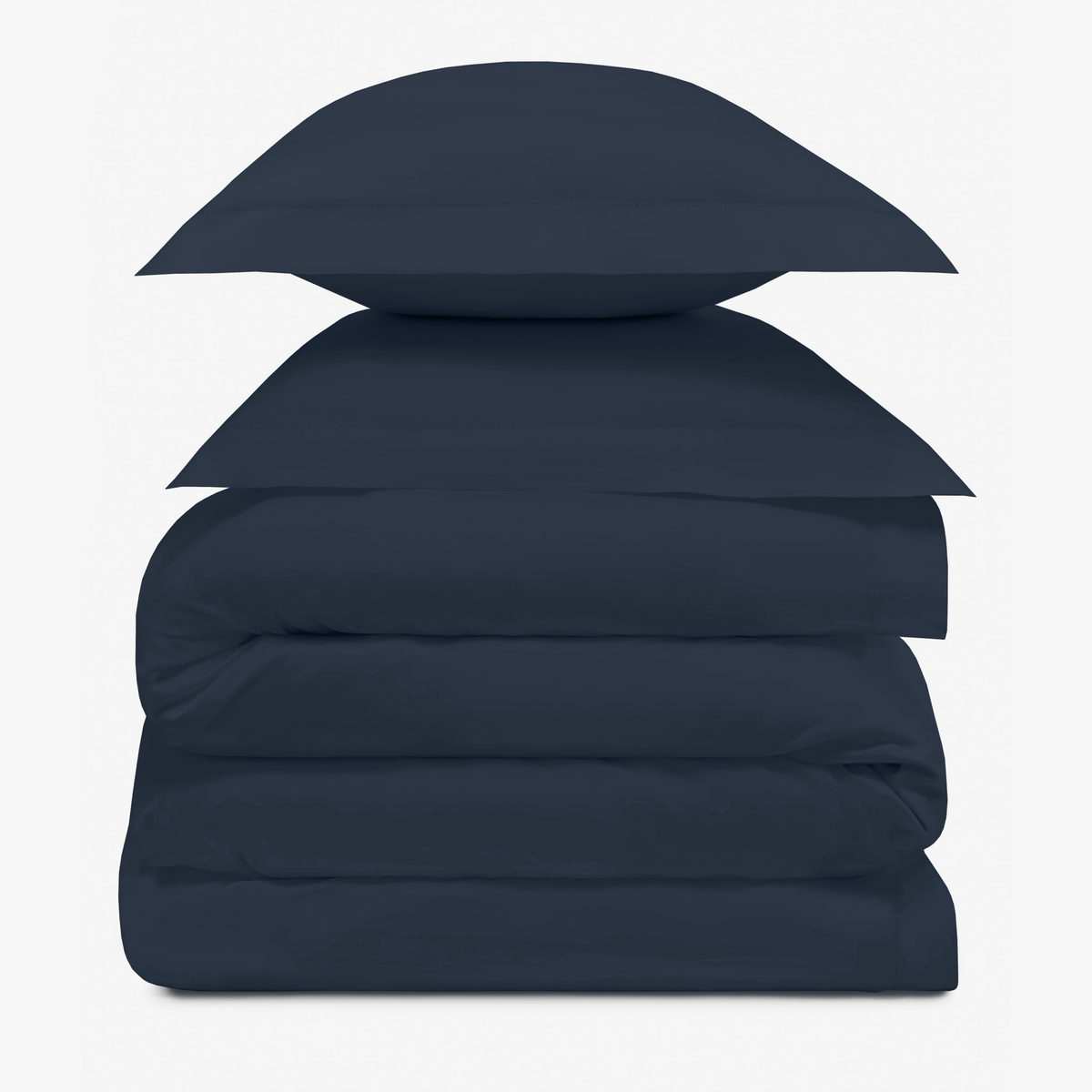 A stack of two Midnight pillows resting on folded Amalia Duvet Bedding Sheets