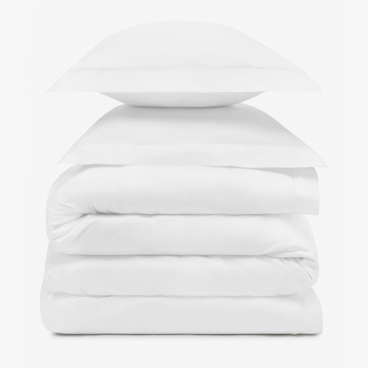 A stack of two White pillows resting on folded Amalia Duvet Bedding Sheets