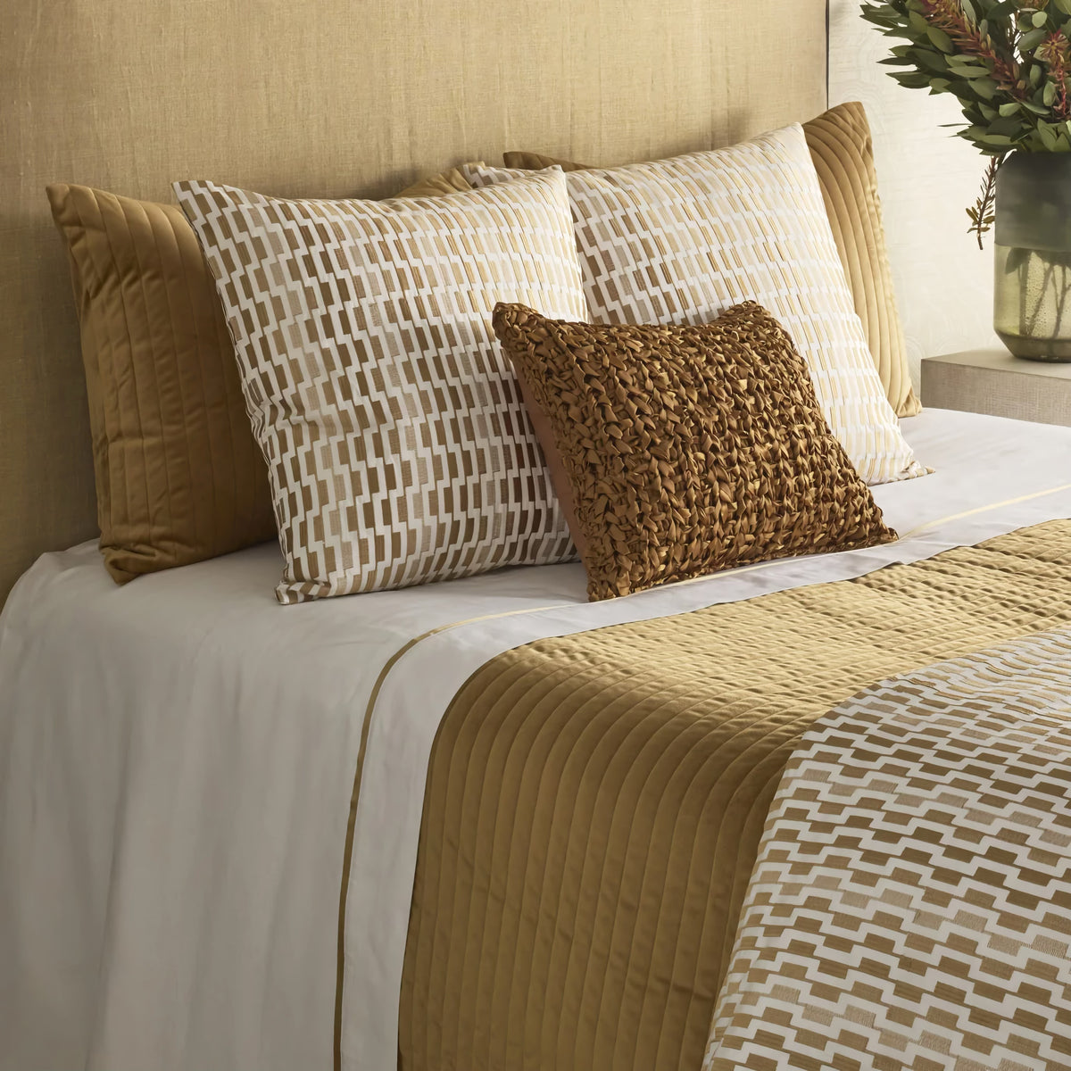 Side view of Camel colored Ann Gish Channel Velvet Coverlet Set with coordinate bedding