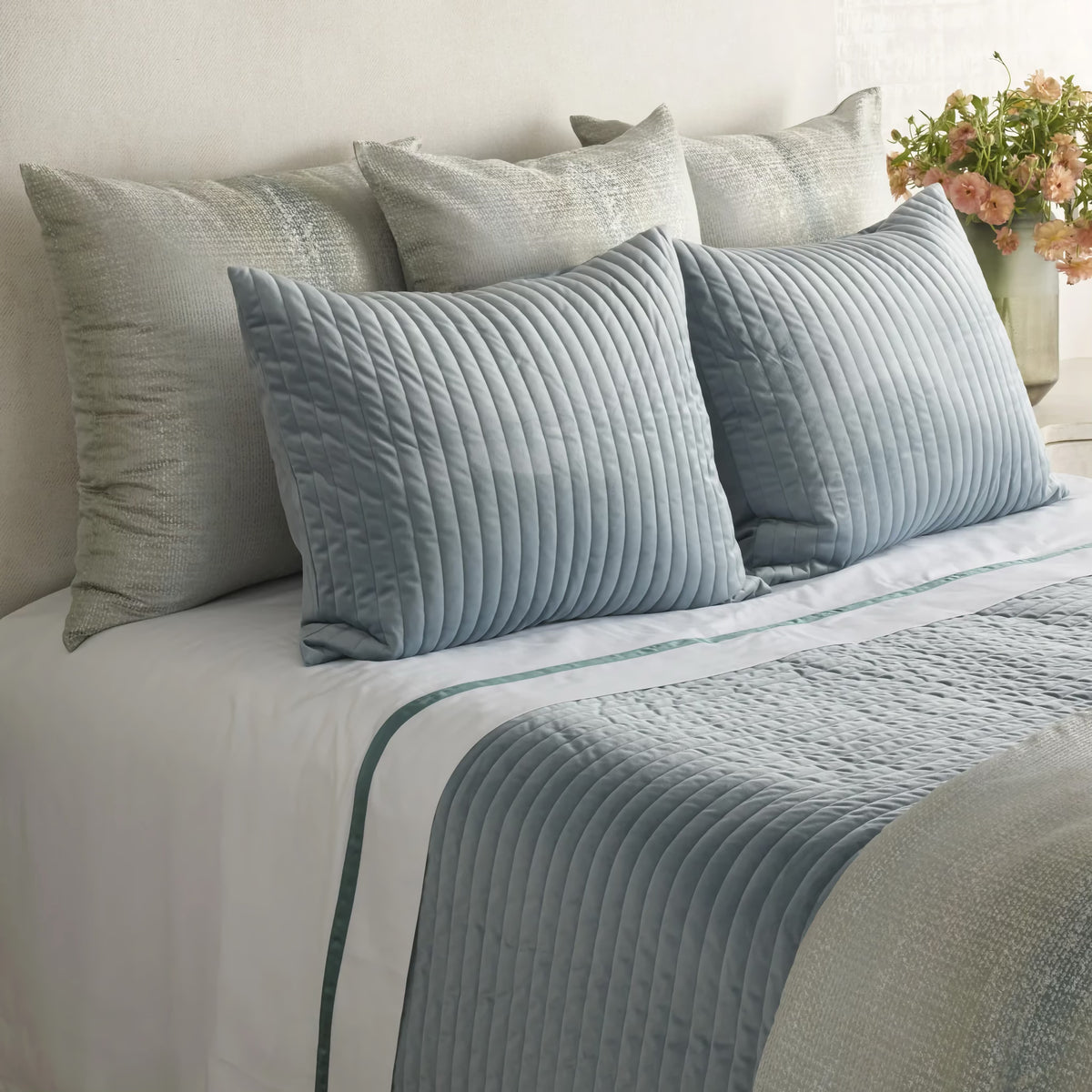 Side view of Sea colored Ann Gish Channel Velvet Coverlet Set with coordinate bedding