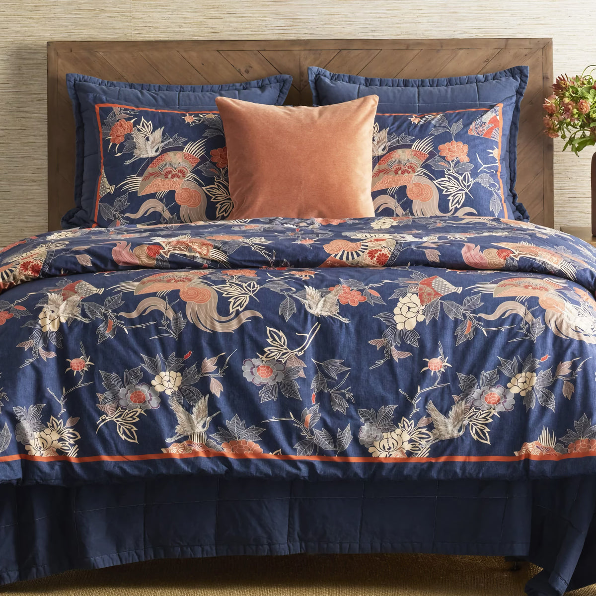 Front view of Denim colored Ann Gish Cotton Canvas Coverlet Set with Patterned bedding as coordinates
