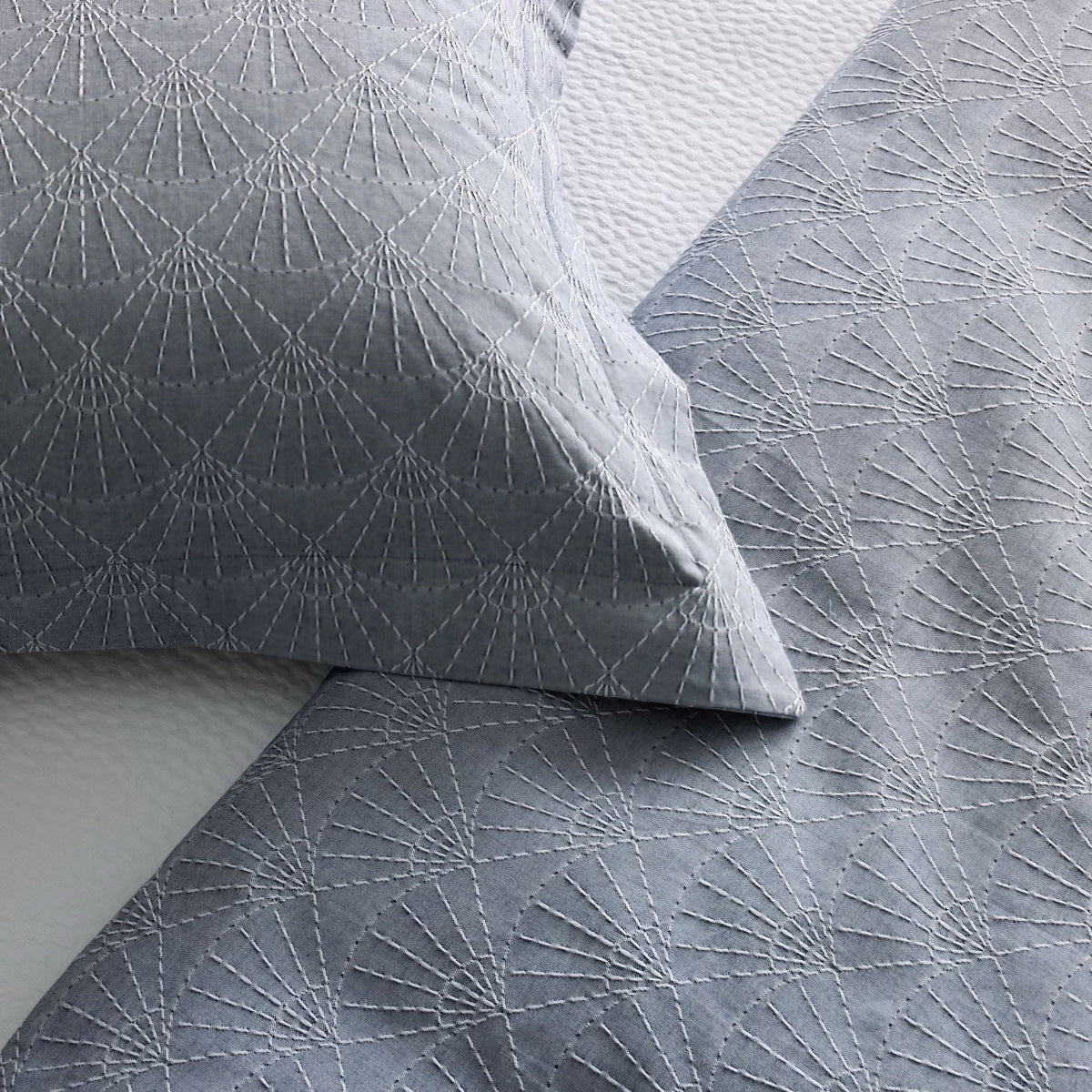Closeup of Indigo-colored Ann Gish Crest Duvet Set