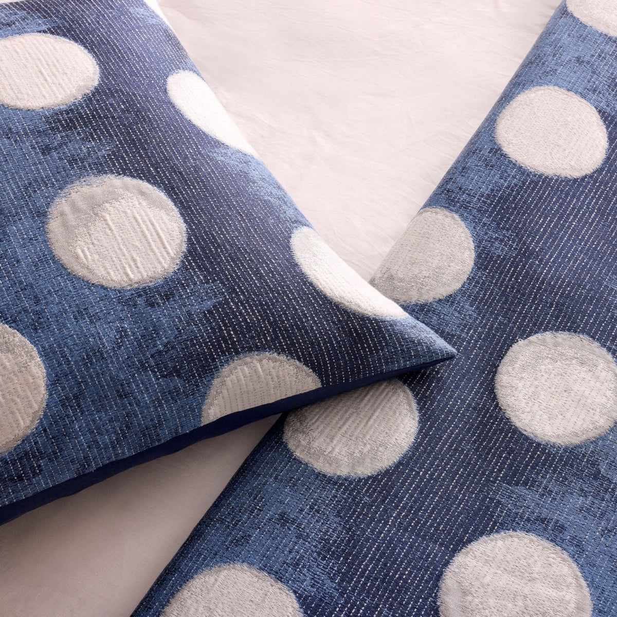 Closeup of Ann Gish Eclipse Throw and Decorative Pillow in Blue and Silver colors