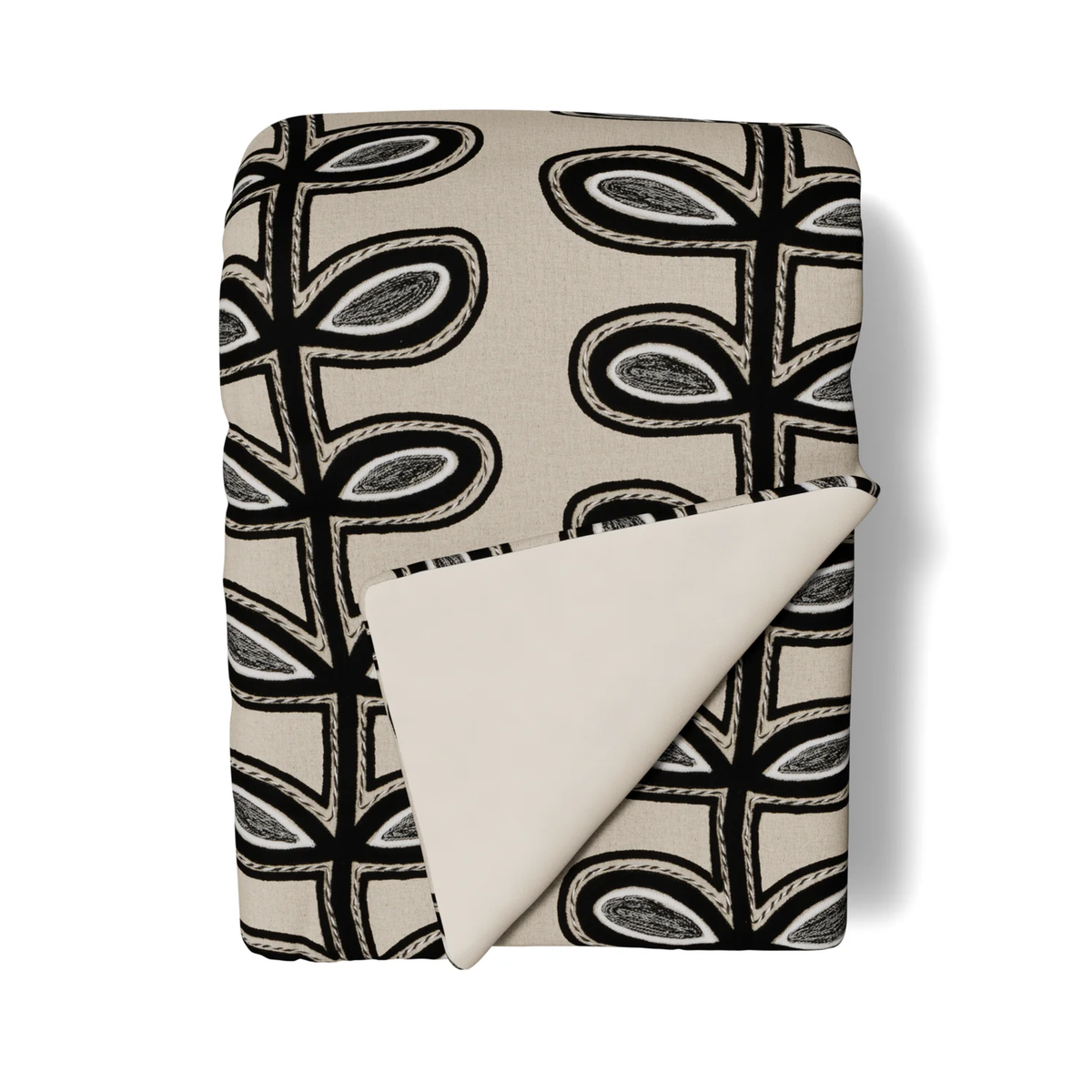 A folded Ann Gish Fellini Throw in Natural and Charcoal colors