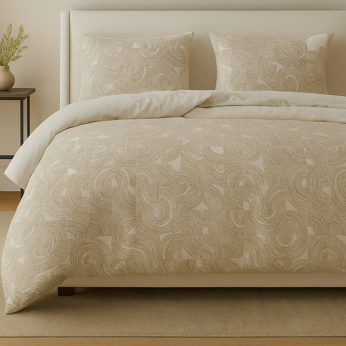 Sandstone-colored Ann Gish Lugano Comforter Set on bed with beige headboard