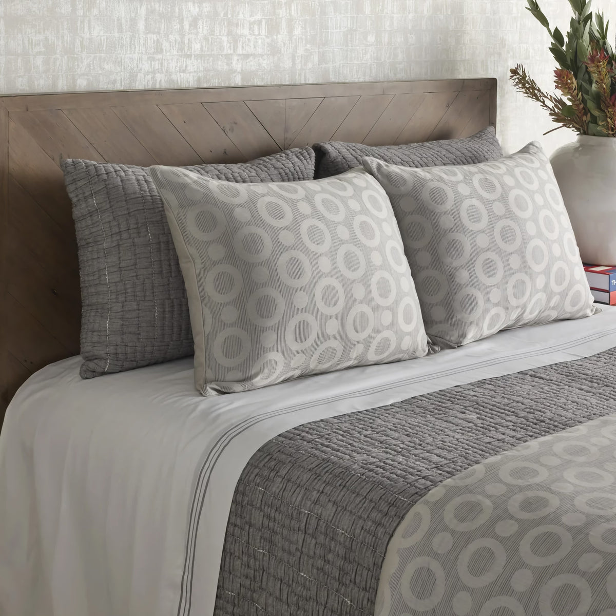 Side view of Charcoal colored Ann Gish Pickstitch Coverlet Set with circular pattern coordinate