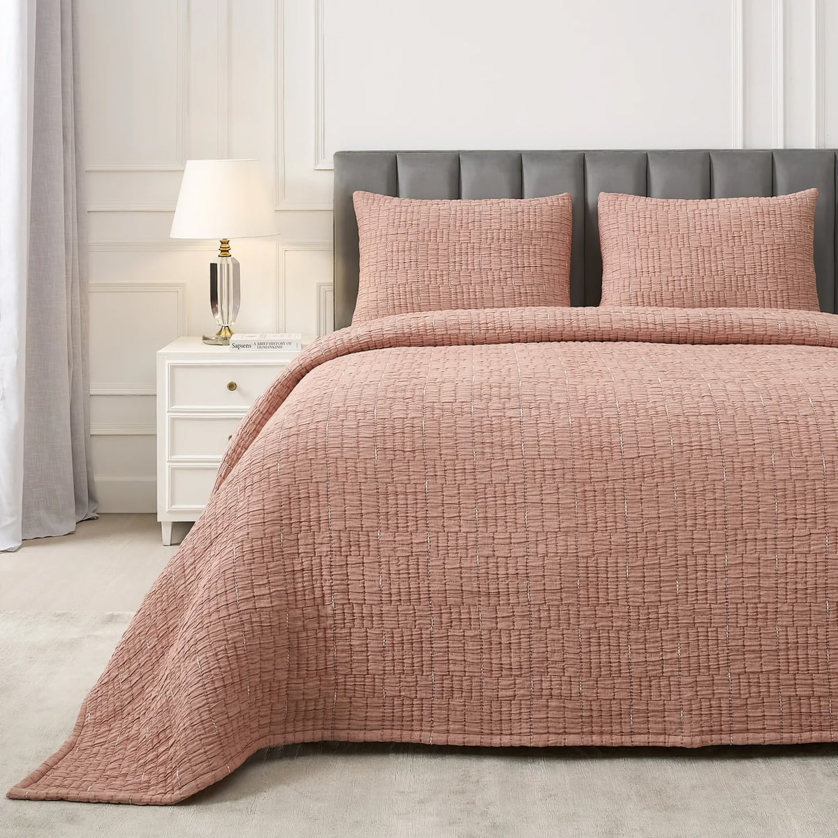 A neatly made bed with a Terra Cotta colored Ann Gish Pickstitch Coverlet Set in a modern bedroom