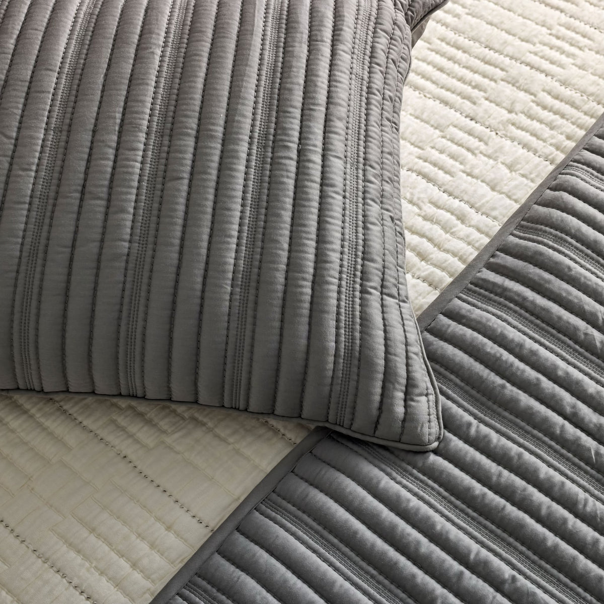 A close-up of Bone and Slate colored Ann Gish Rib Coverlet Set