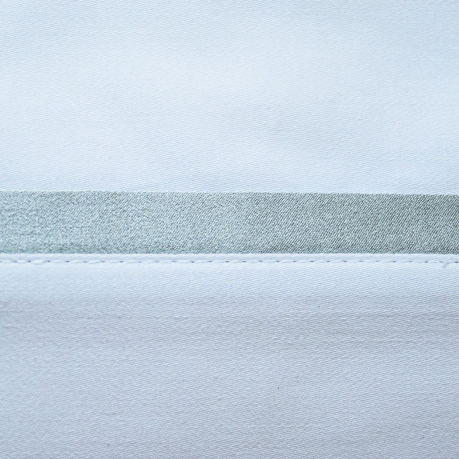 Side View of Ann Gish Silk Trim Bedding with Frost Swatch