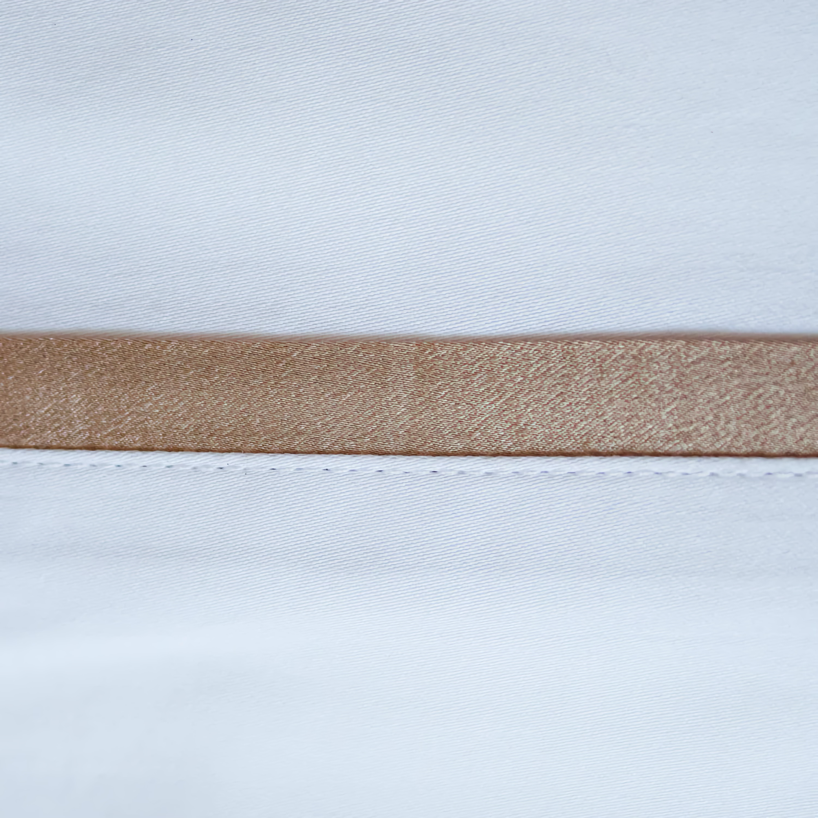 Side View of Ann Gish Silk Trim Bedding in Sand