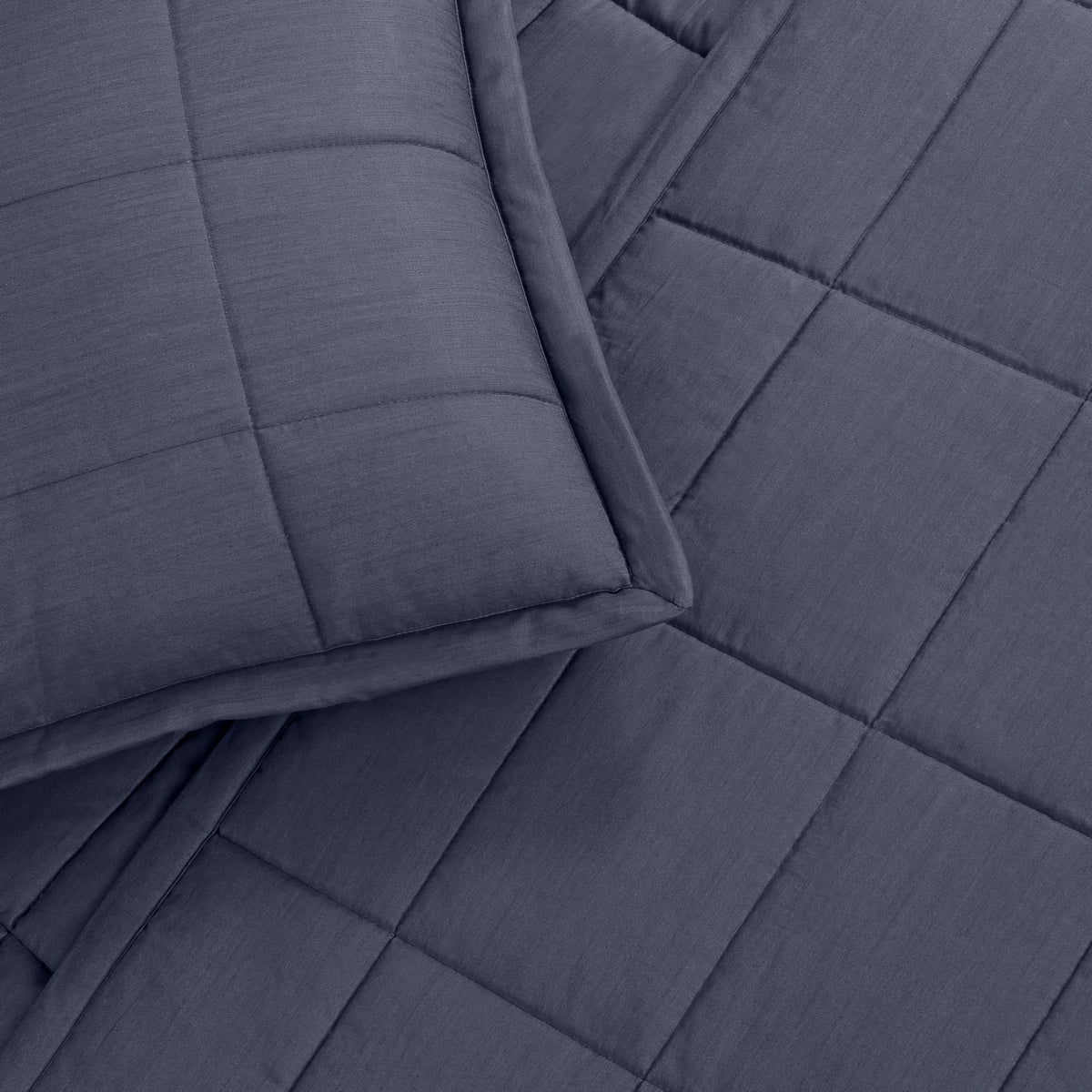 A close-up of a Marine colored Ann Gish Slub Tencel Quilted Coverlet Set