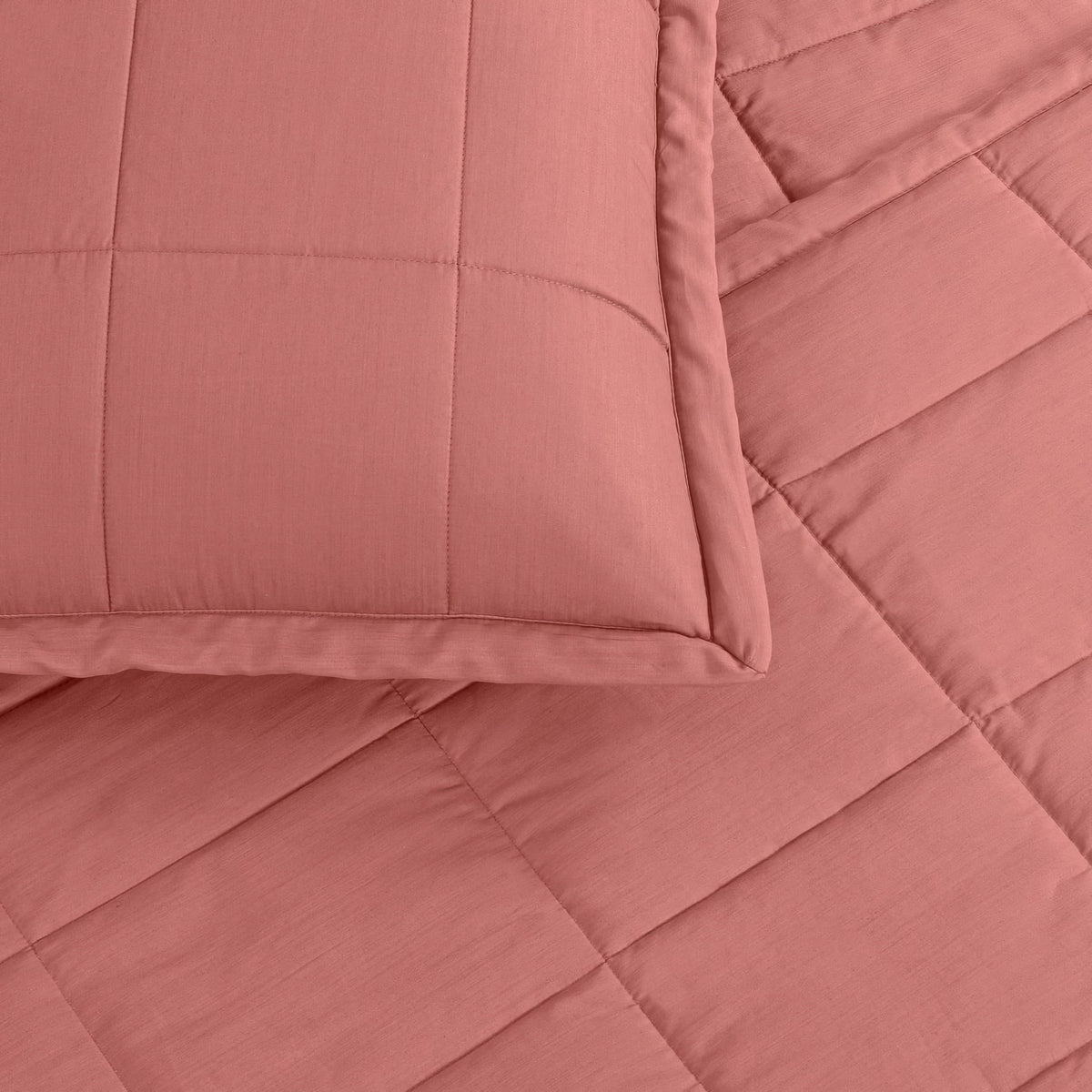 A close-up of a Persimmon colored Ann Gish Slub Tencel Quilted Coverlet Set