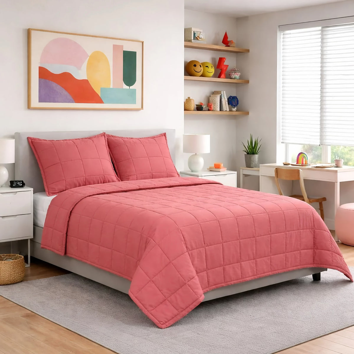 A bed with a Persimmon colored Ann Gish Slub Tencel Quilted Coverlet Set in a modern bedroom with shelves, wall art, lamps, and window blinds