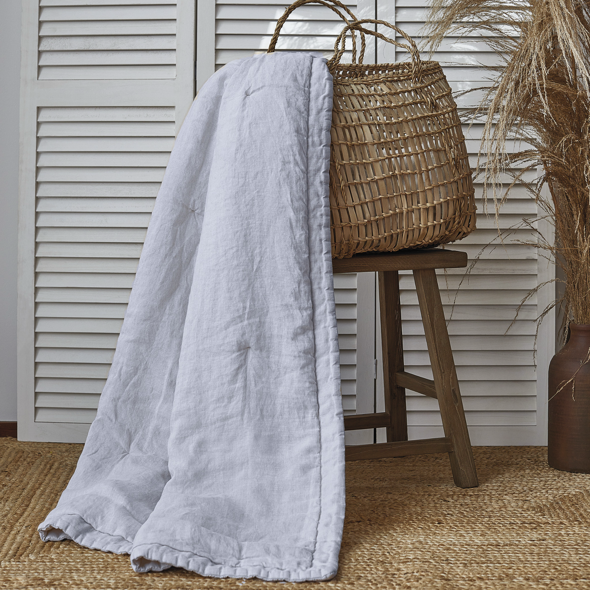 White BOVI Madeira Coverlet Hanging from a basket