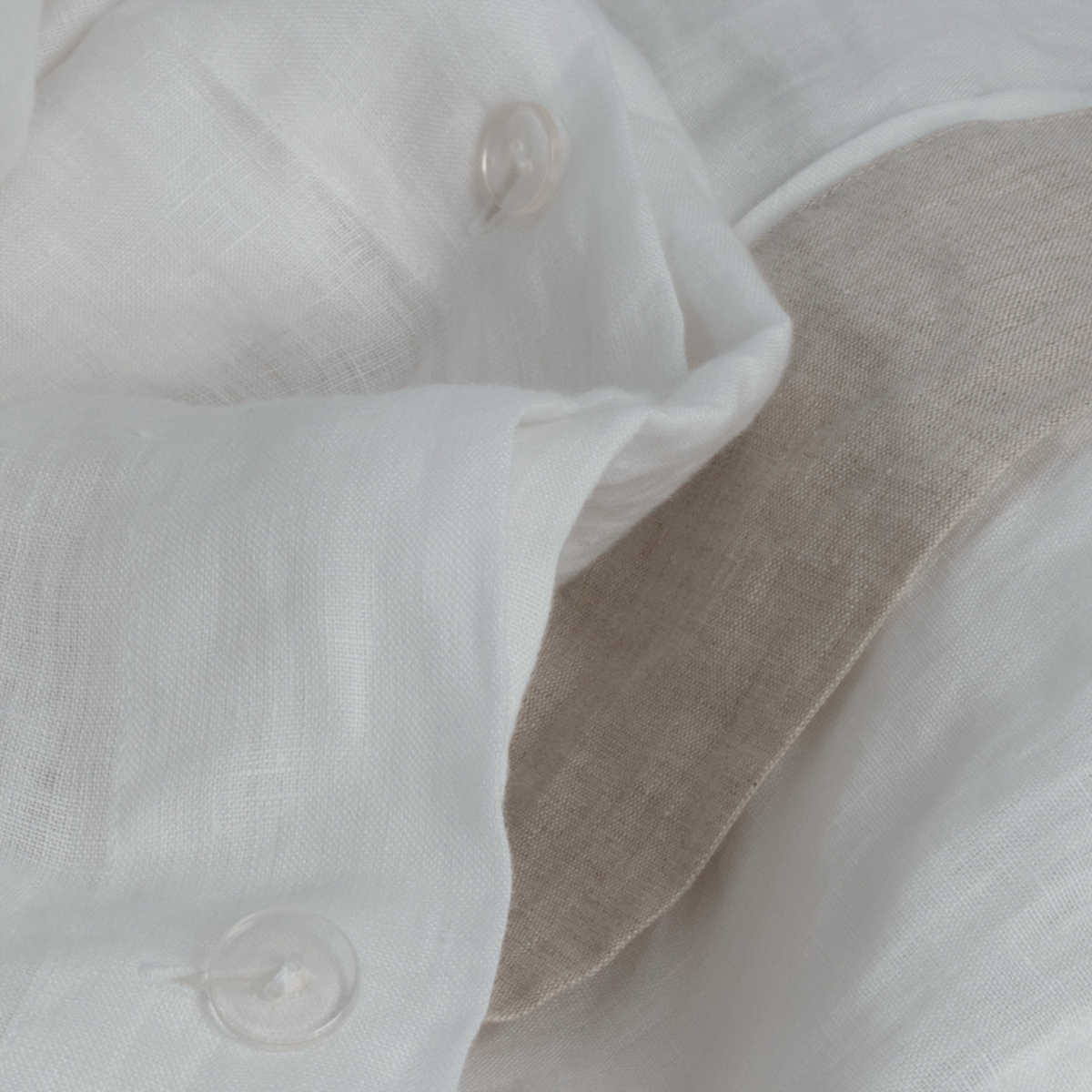 Button Closure of BOVI Marbella Bedding in White and Flax colors