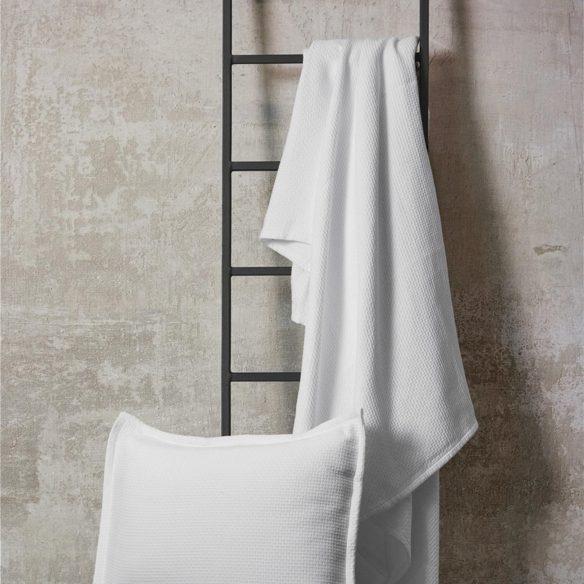 White BOVI PJ Pique Coverlet and Shams on a ladder
