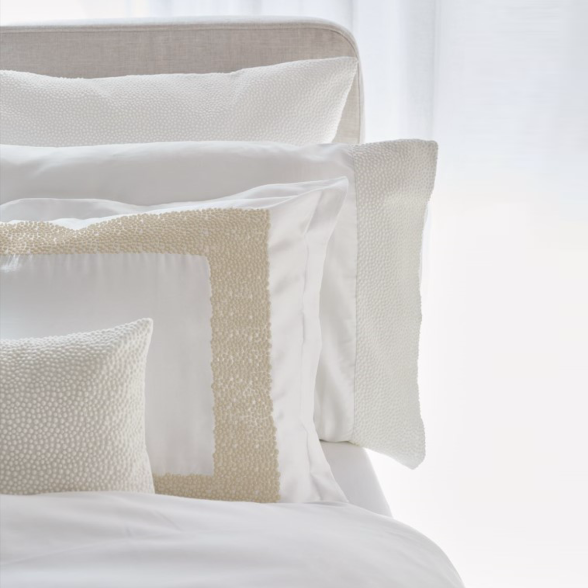 Closeup of BOVI Pearls Bedding in White and Latte Colors
