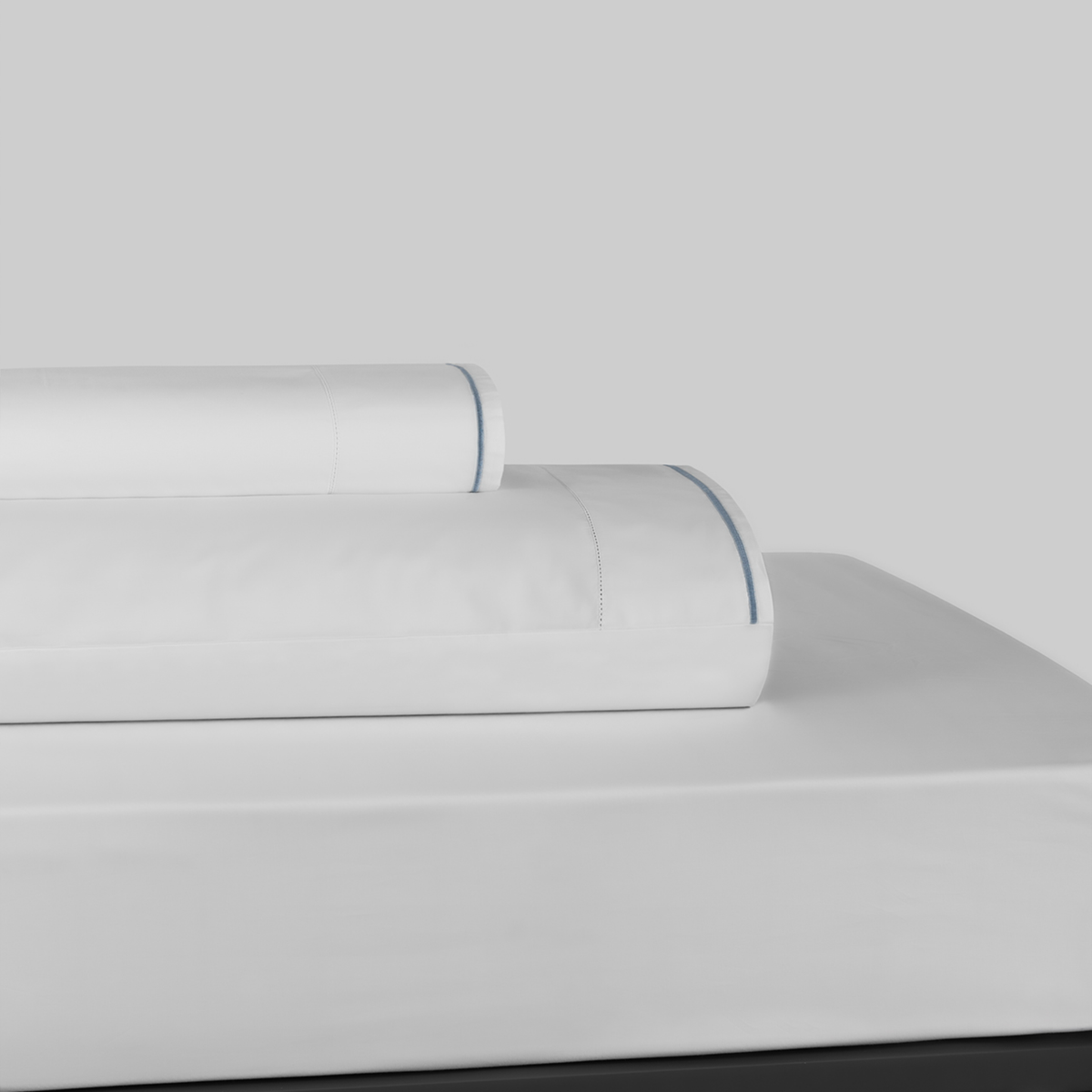 Stack of White and Ocean Blue BOVI Sierra Bedding Sheet Set