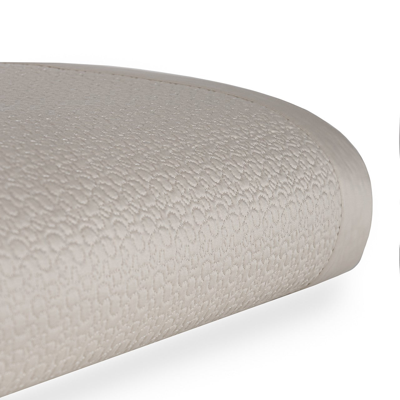 Bovi Estella Coverlet in White and Latte, stacked and displayed on a table with a plant in the background