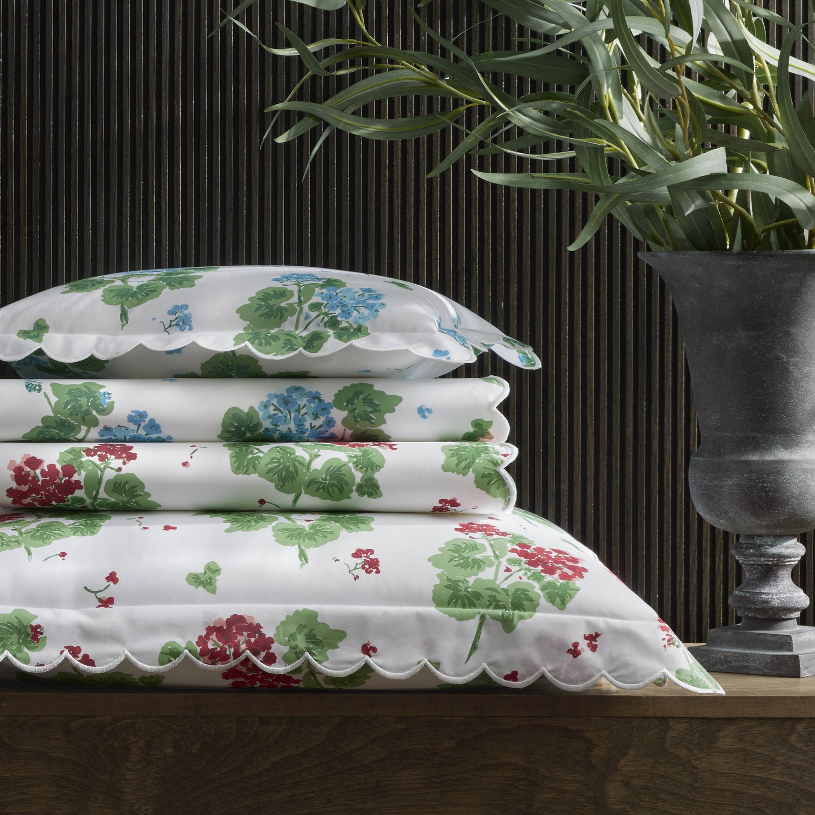 Floral-patterned quilt with a plant in the background