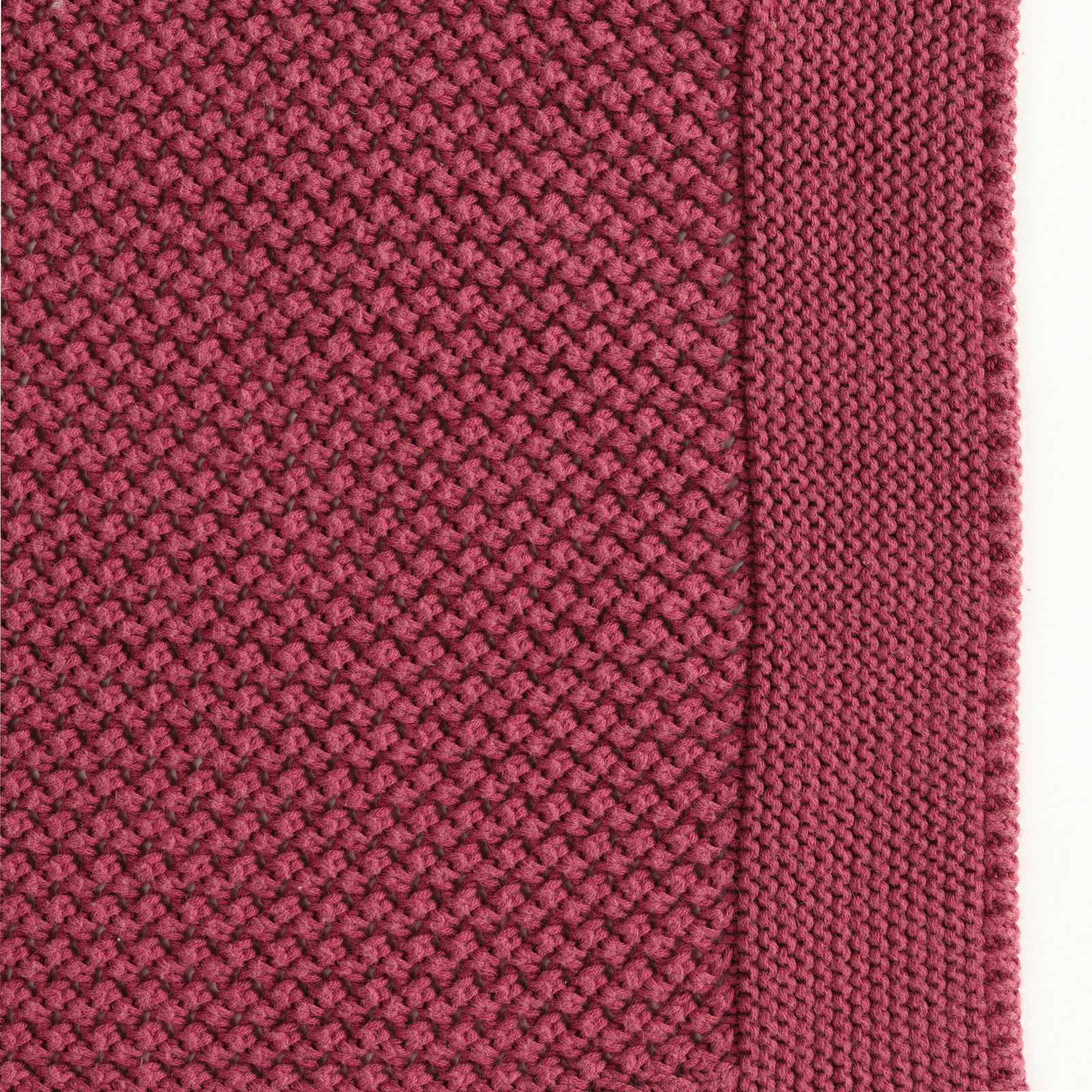 Celso de Lemos Balade Throw in Cardinal Color on a Bed