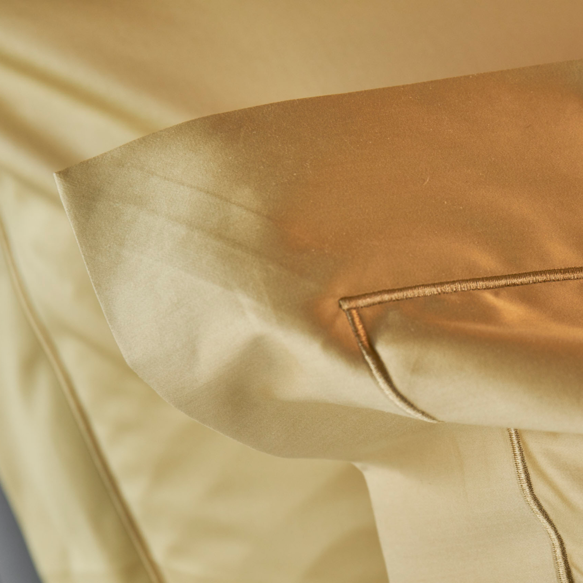 Lifestyle Shot of Gold Pillowcase of Celso de Lemos Bourdon Bedding
