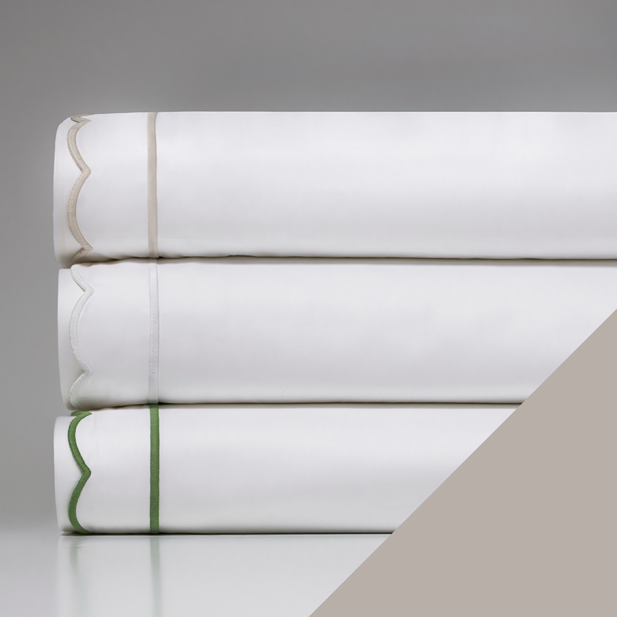 A stack of Downtown Company Scallop Bedding with Pearl swatch