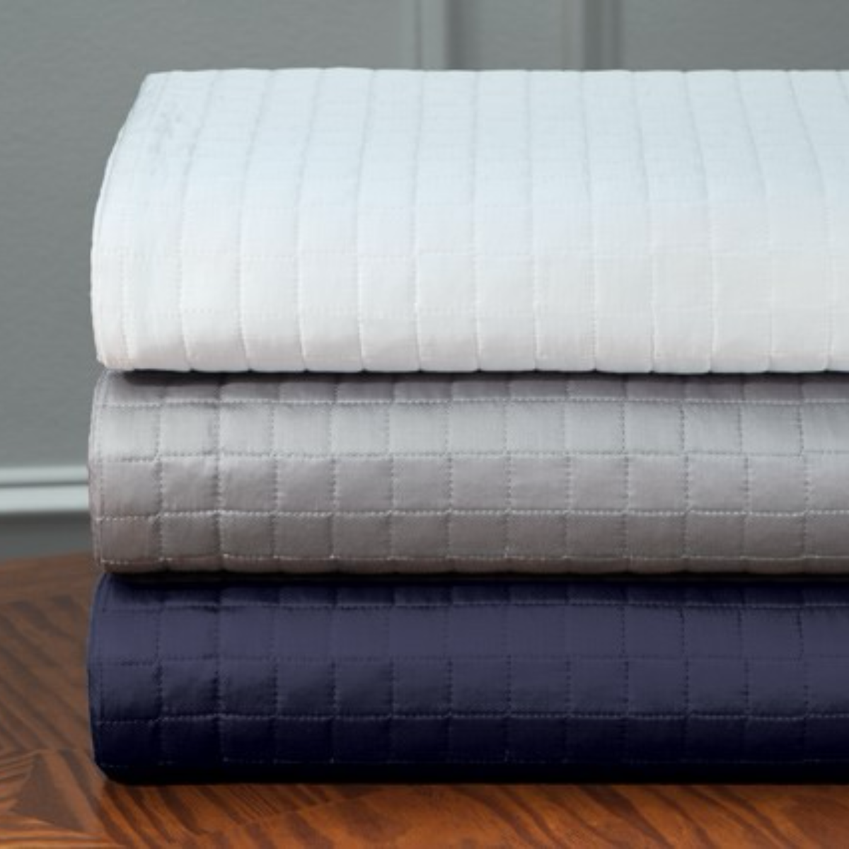 Stack of Downtown Company Urban Quilted Coverlets and Shams Showing All Colors