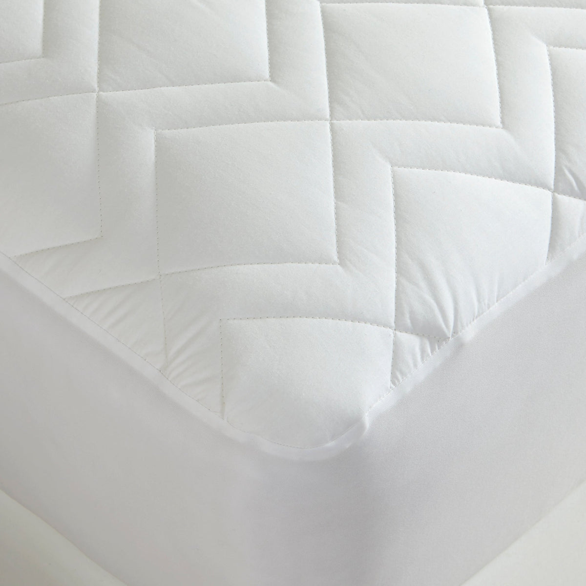 Closeup View of Downtown Company Waterproof Quilted Mattress Pad In Color White