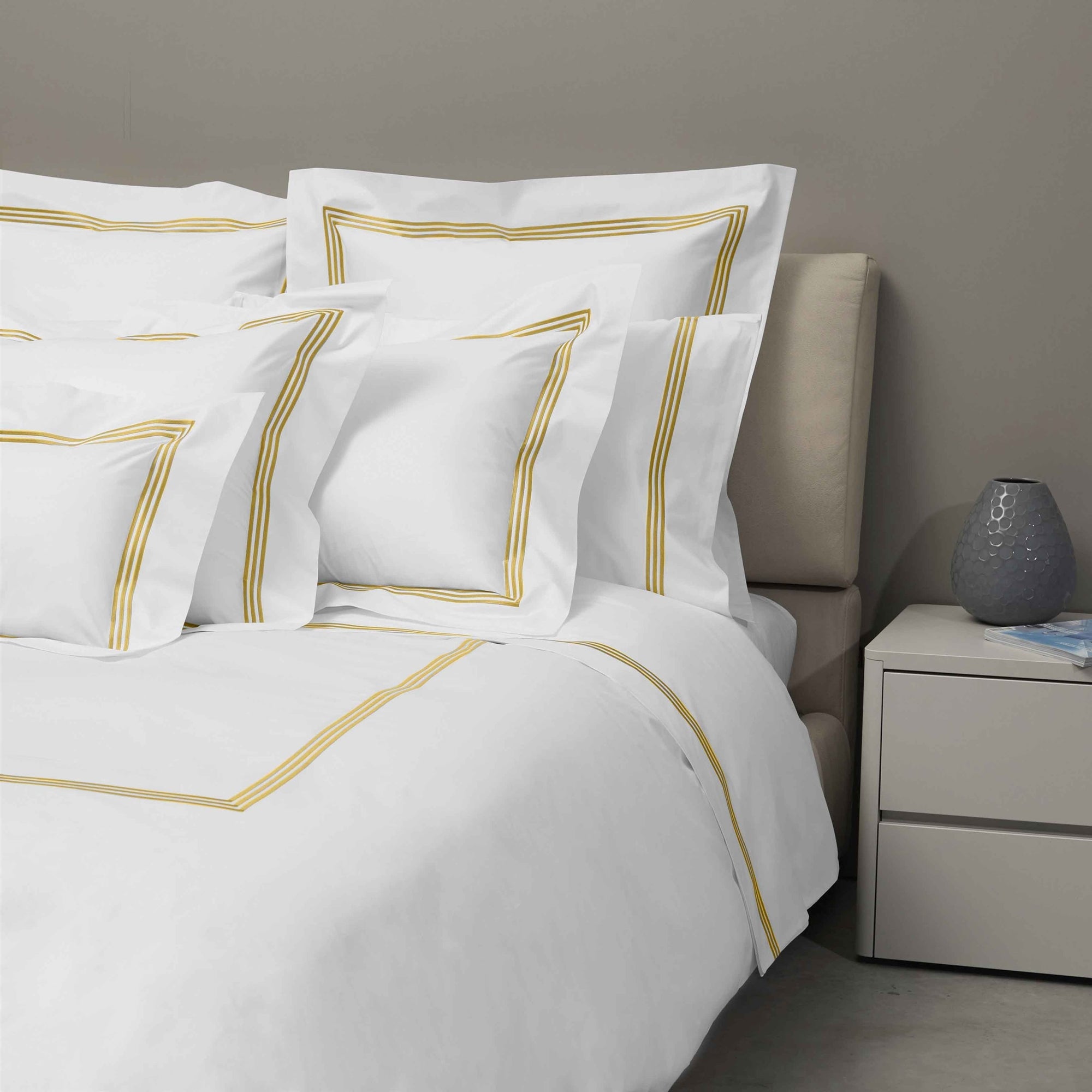 Bed Dressed in Signoria Platinum Percale Bedding in White/Gold Color
