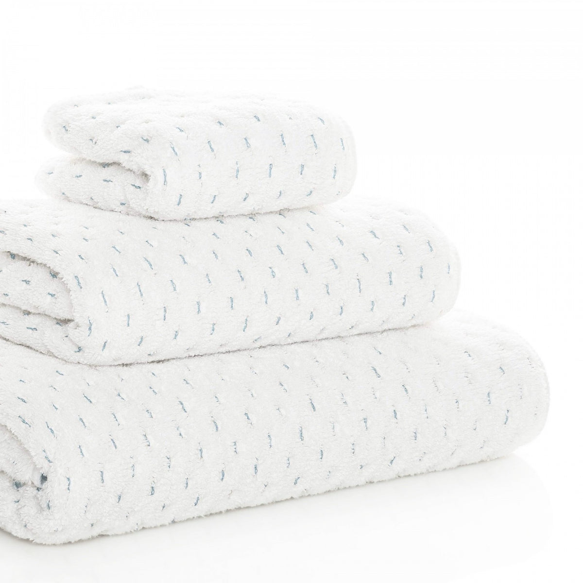 Stack of Graccioza Alice Bath Towel in White and Sea Mist colors at an angle