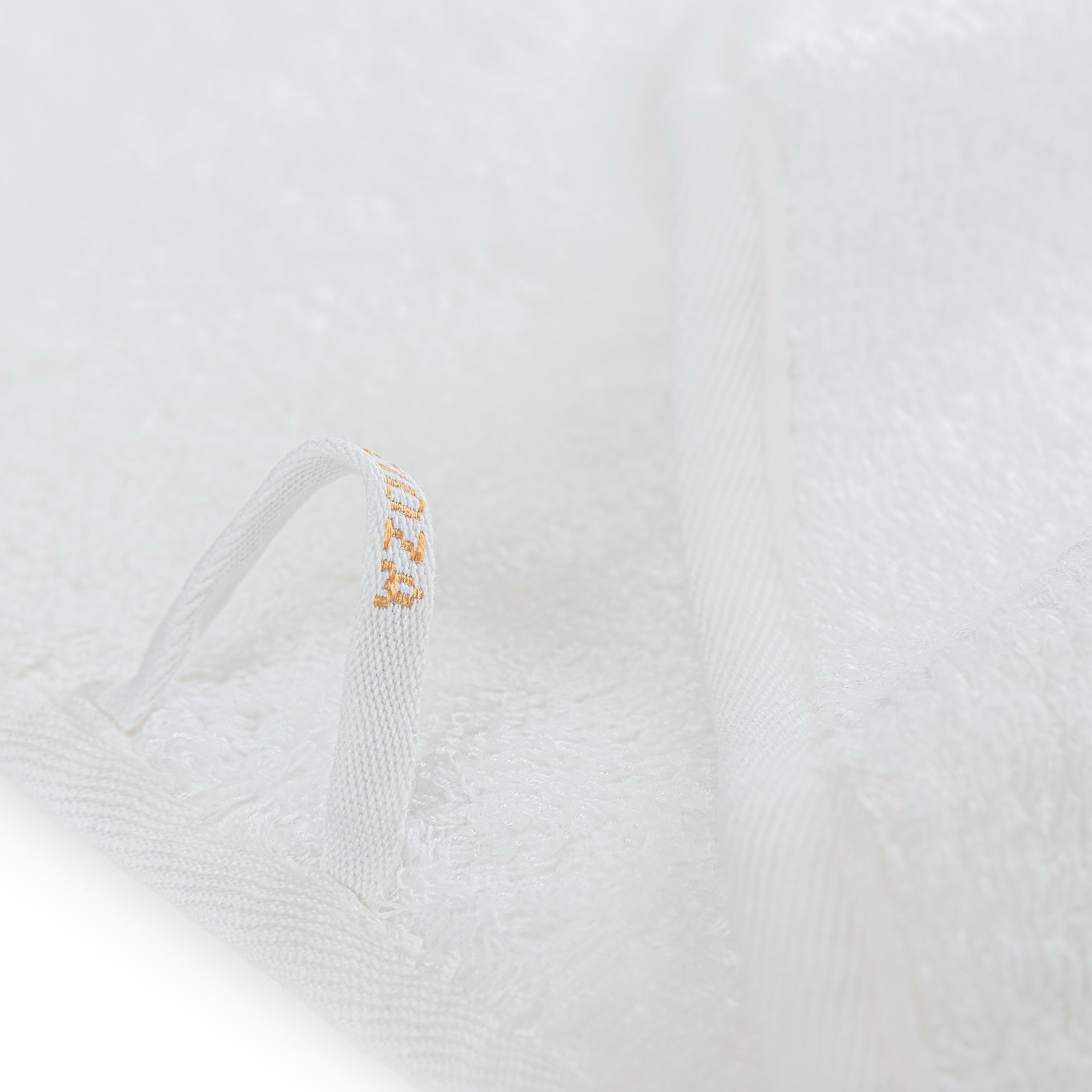 Stack of White Graccioza Tecnic Bath Towels in the woods