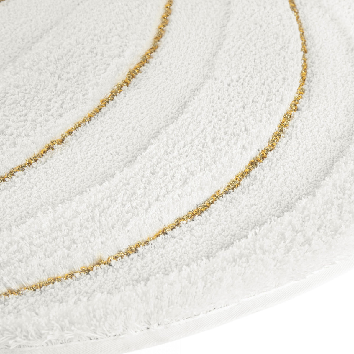 A white circular Graccioza Enchant bath rug featuring two thin, gold curved lines.