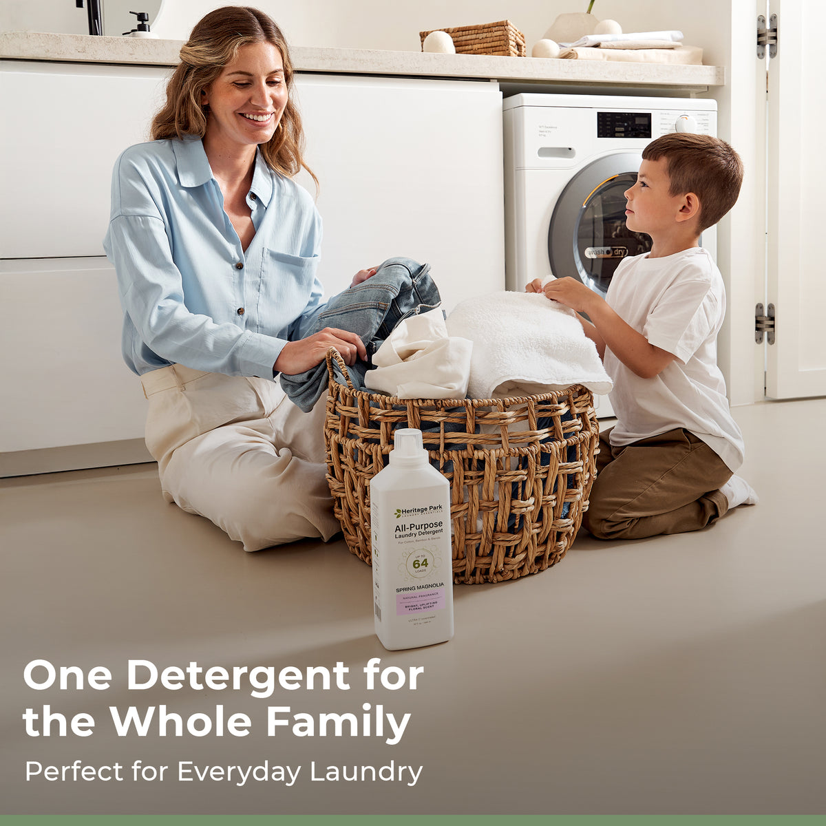 Woman and child with laundry basket in kitchen, Heritage Park Spring Magnolia All Purpose detergent bottle in foreground