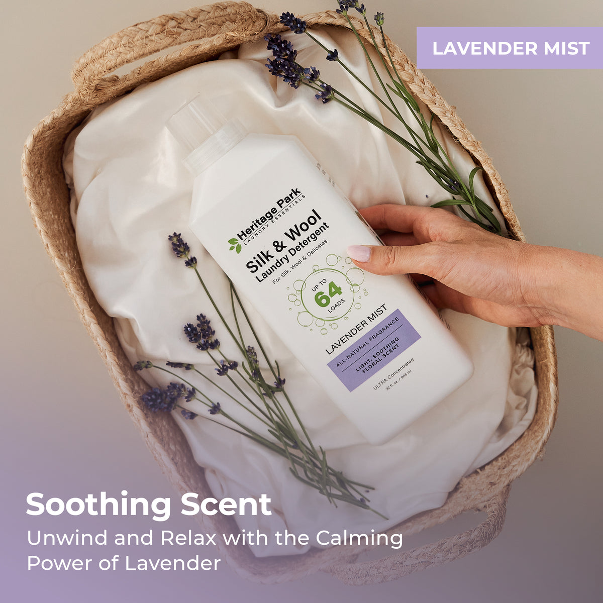 Hand holding a bottle of Heritage Park Silk and Wool Lavender Mist Laundry Detergent in a woven basket with text highlighting its properties